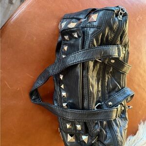 Studded barrel handbag with red lining